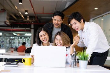 Portrait of successful startup business team. Diverse business people standing together happy and...