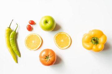 Top view fresh fruit, vegetables and wholegrains organic pepper, tomato, apple, orange on white background. Free text copy space concept.