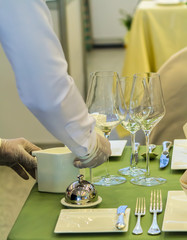 Waiter decorate and setting luxury party dinner table in restaurant.