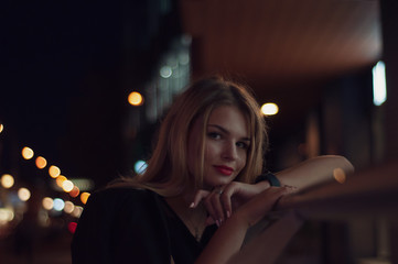 Art portrait of a beautiful girl. gorgeous blonde girl, portrait in night city lights.