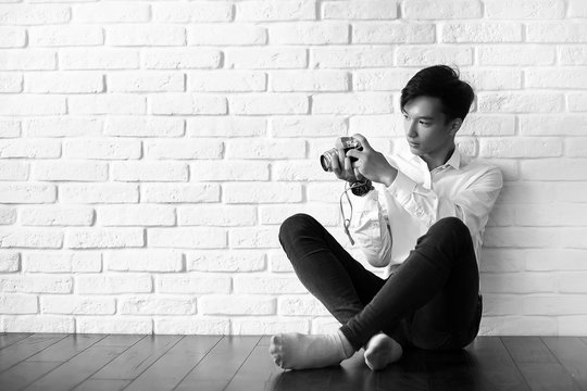 Asian man with a camera black and white