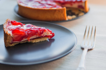 Classic cheesecake with strawberry slices in jelly on top.