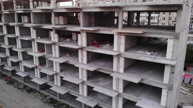 View from the drone of a multi-apartment high-rise building during construction.