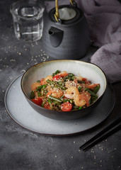 Noodles with shrimps and vegetables, Asian cuisine, Glass chinese noodles, Gray background, Selective focus