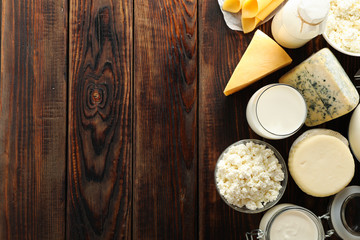 Flat lay. Different dairy products on wooden background, copy space