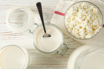 Different dairy products on white wooden background, top view