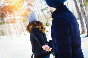 Couple follow me. Woman leads a man to winter park