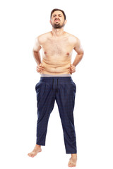 Fototapeta premium A young man is unhappy with fat on his stomach. Isolated over white background. Vertical.