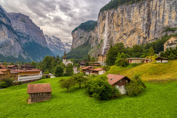 Amazing view of famous Lauterbrunnen town in Swiss Alps valley with beautiful Staubbach waterfalls...