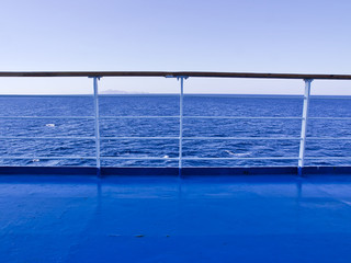 Fototapeta na wymiar Ferry deck and railings with sea and horizon line background.