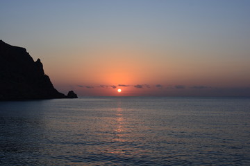 sunrise over sea, and silhouette of Cabo de San Antonio, Javea, Spain