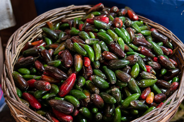 Mix of Green and red Jalapeno peppers at market stall in Yenifoca in Izmir province. Spicy food at weekly farmers market in Turkey.