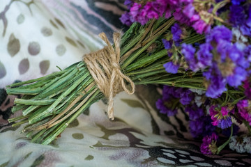 Bouquet of field and arid flowers on cloth with leopard and zebra print.