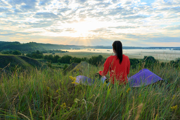 Fototapeta premium Girl in the nature doing yoga exercise for fitness.