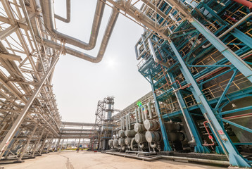 low angle view of metal pipes of industrial plant outdoor 
