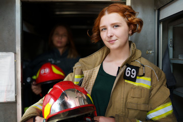 Photo of two female firefighters in fire truck