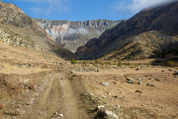Photo of mountainous landscape, road , cloudy sky on summer
