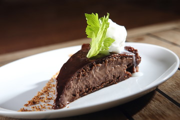 Chocolate dessert with peanut and walnut pieces.