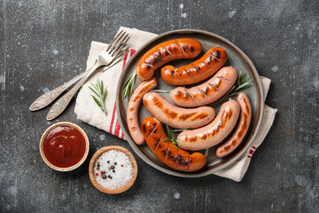 Grilled sausages with ketchup and salt