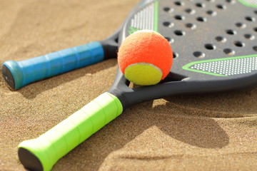 Beach tennis rackets in the sand