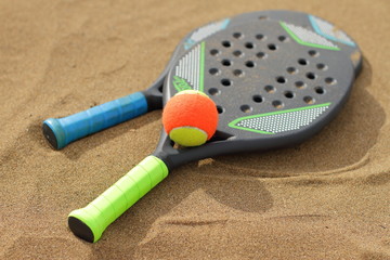 Beach tennis rackets in the sand