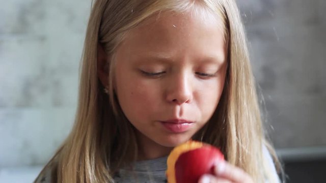little girl eating peach, plum closeup