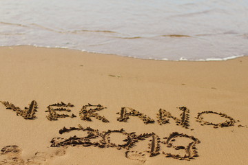 Verano, 2019, word summer is written on the sand 