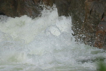 water falling between rocks from waterfalls