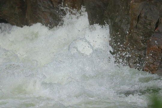 water falling between rocks from waterfalls
