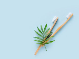 Zero waste and minimalism concept. Wooden, bamboo thoothbrush ecological  theme on blue background