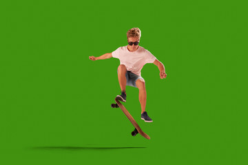 Fototapeta na wymiar Skateboarder on green screen background.