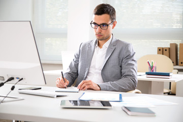 Serious businessman working with computer