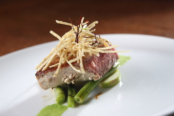Roasted fresh tuna loin with garnish of apples, peas and tortilla strips.