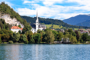 Fototapeta na wymiar Church of St. Martin on lake of Bled. The current neo-Gothic church, dedicated to Saint Martin, was built in 1905 where a Gothic church of the 15th century once stood.