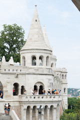 Fototapeta premium Budapest / Hungary - July 28 2019: Stairs and statues of the historic Fisherman's Bastion in Budapest city, Hungary. Group of tourist in a famous place