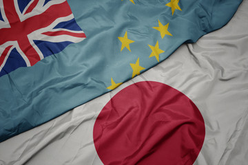 waving colorful flag of japan and national flag of Tuvalu.