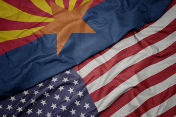 Obraz premium waving colorful flag of united states of america and flag of arizona state.