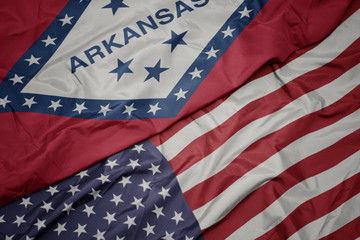Fototapeta na wymiar waving colorful flag of united states of america and flag of arkansas state.