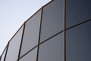 Glass architecture. Double-exposure tilt photo of contemporary office building facade
