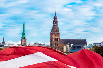 Riga, Latvia Flag and Old Town, view of Riga Castle, Cathedral, St. Peter