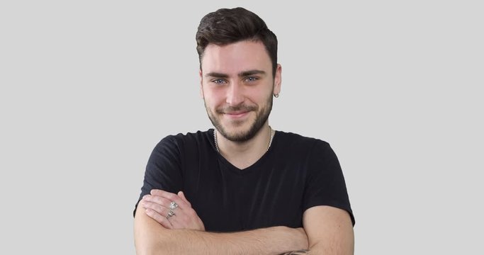 Stylish hipster man with arms crossed over white background