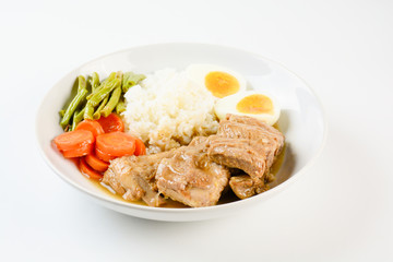 Baked pork ribs with rice, boiled egg and vegetable