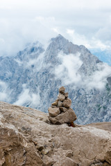 Stones cairn bridging on Zugspitze peak, Alps, Germany. Bavarian Alps on background. Touristic, hiking concept