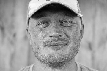 Portrait of caucasian man in a cap, close up, black and white