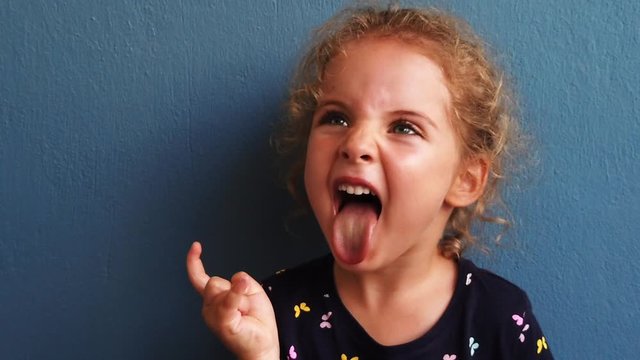 Adorable 4 years old girl is having fun with her funny face.