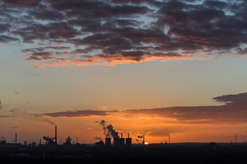 Sonnenuntergang an der Sechs-Seen-Platte in Duisburg mit Blick auf die rauchenden Schlote am Horizont