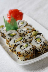 Sushi is traditionally made with medium-grain white rice. It is very often prepared with seafood, such as squid, eel, yellowtail, salmon, tuna or imitation crab meat.