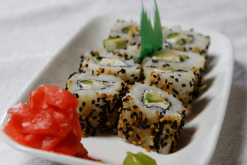 Sushi is traditionally made with medium-grain white rice. It is very often prepared with seafood, such as squid, eel, yellowtail, salmon, tuna or imitation crab meat.