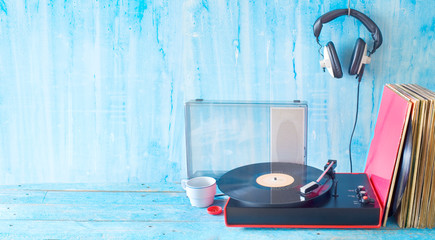 Old turntable, vinyl records, headphones, vintage audio gear, analog music concept, free copy space