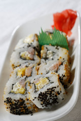 Sushi is traditionally made with medium-grain white rice. It is very often prepared with seafood, such as squid, eel, yellowtail, salmon, tuna or imitation crab meat.